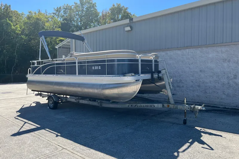 Slide: The Image of 2014 Bennington 22SSX pontoon boat on trailer, parked outdoors. - 5