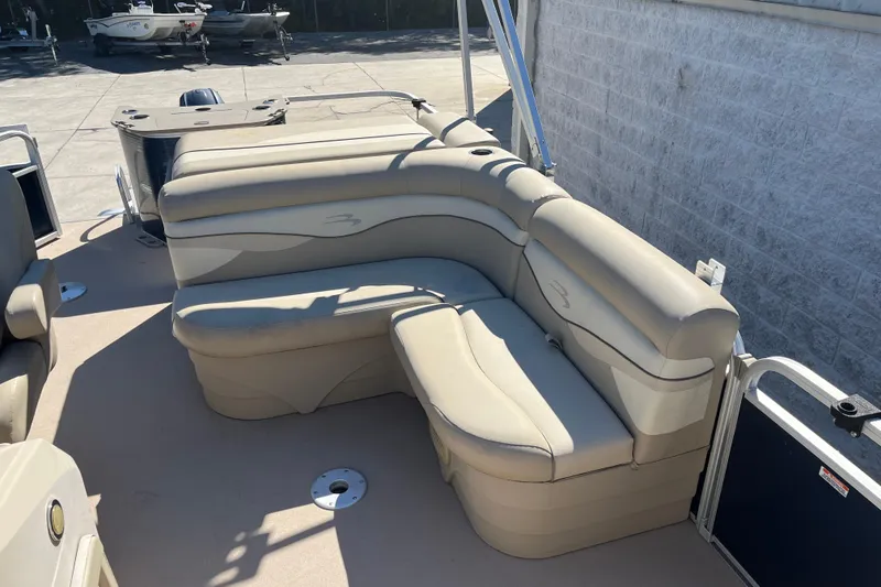 Slide: The Image of 2014 Bennington 22SSX pontoon boat with beige seating and spacious deck area. - 8
