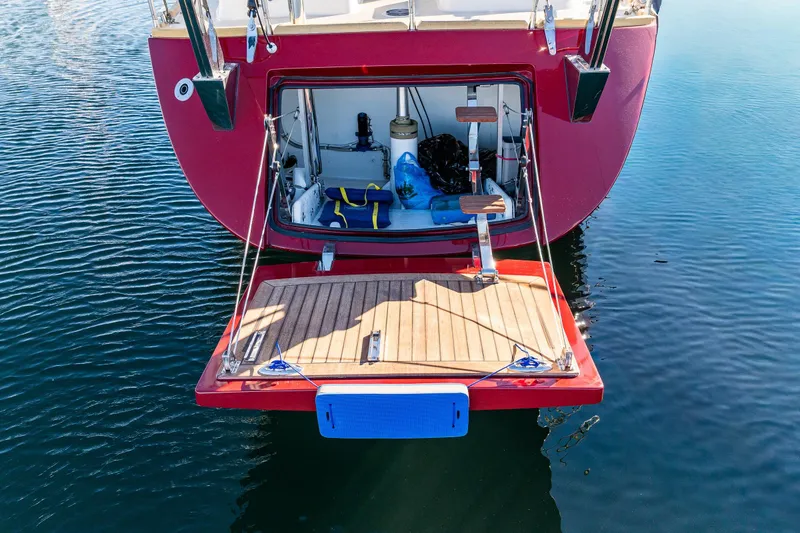 Slide: The Image of Red Ron Holland 50 yacht stern with open storage, docked on calm water, 2013 model. - 10