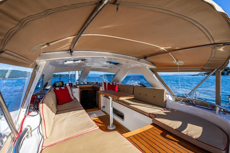 Slide: The Image of Luxurious Ron Holland 50 yacht interior with beige seating, wooden flooring, and scenic ocean view. - 13