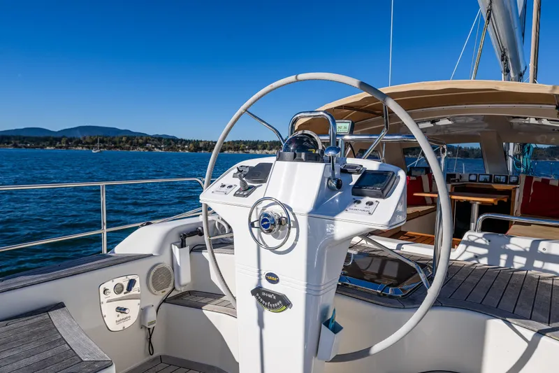Slide: The Image of Steering wheel of 2013 Ron Holland 50 yacht with ocean view and clear blue sky. - 17