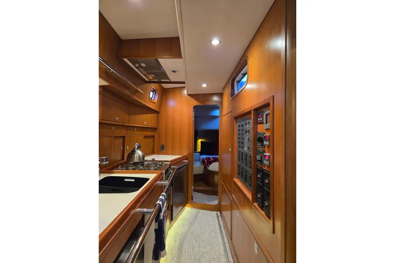 Slide: The Image of Luxurious interior of a 2013 Ron Holland 50 yacht, featuring a modern galley and cozy cabin. - 28