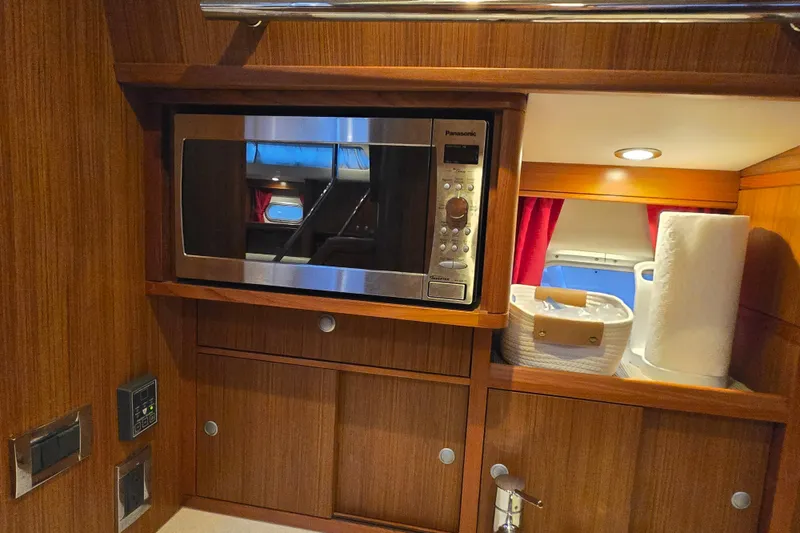 Slide: The Image of 2013 Ron Holland 50 yacht interior with microwave and storage area. - 31