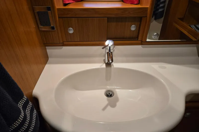 Slide: The Image of Luxurious bathroom sink in 2013 Ron Holland 50 yacht, featuring elegant wood cabinetry. - 38