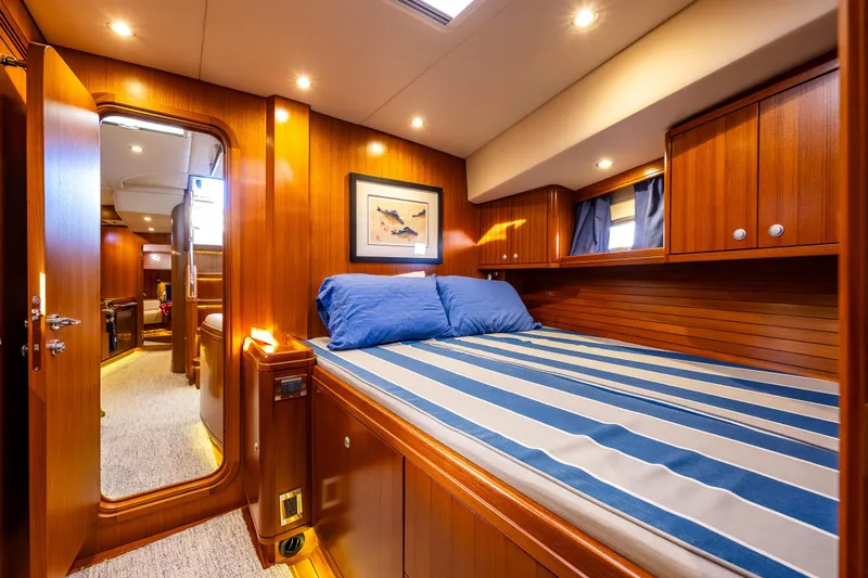 Slide: The Image of Luxurious 2013 Ron Holland 50 yacht cabin with wood paneling and striped bedding. - 39