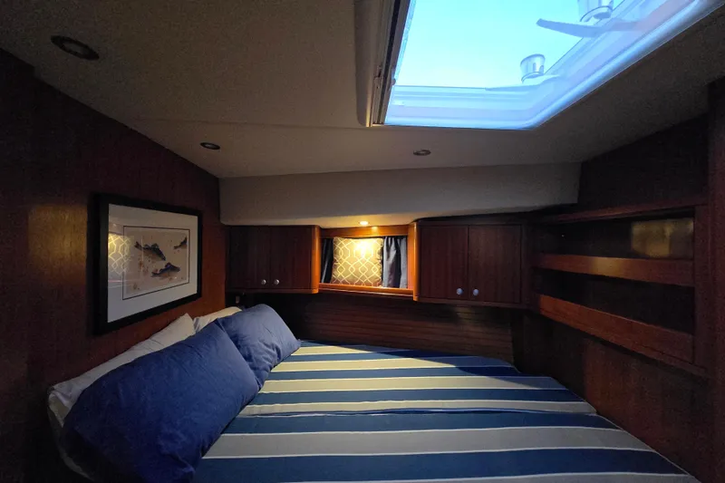 Slide: The Image of Cozy cabin interior of 2013 Ron Holland 50 yacht with skylight and striped bedding. - 40