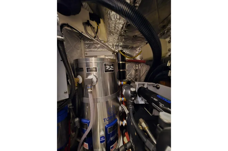 Slide: The Image of Engine room of a 2013 Ron Holland 50 yacht, featuring mechanical components and wiring. - 44