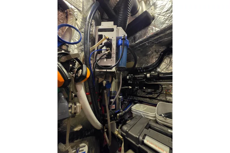 Slide: The Image of Engine room of a 2013 Ron Holland 50 yacht, featuring complex piping and equipment. - 45