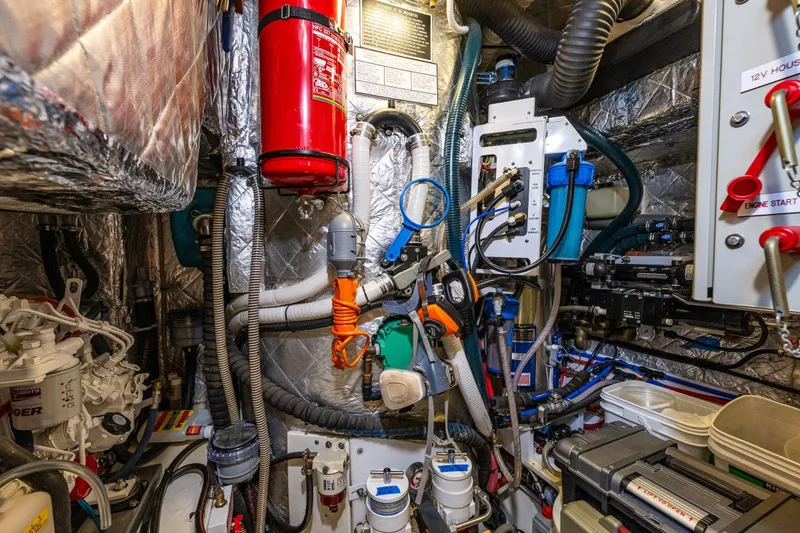 Slide: The Image of Engine room of a 2013 Ron Holland 50 yacht, featuring complex machinery and wiring. - 46