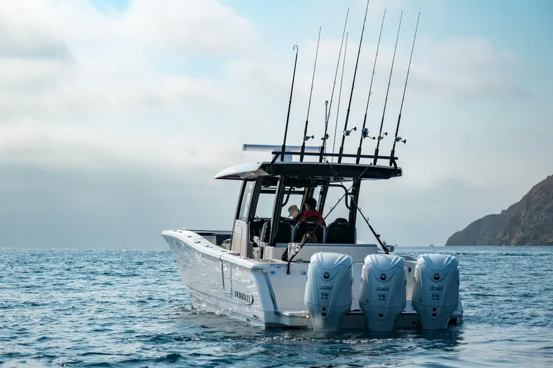 Slide: The Image of 2025 Robalo R360 Center Console boat with triple engines on open water. - 19