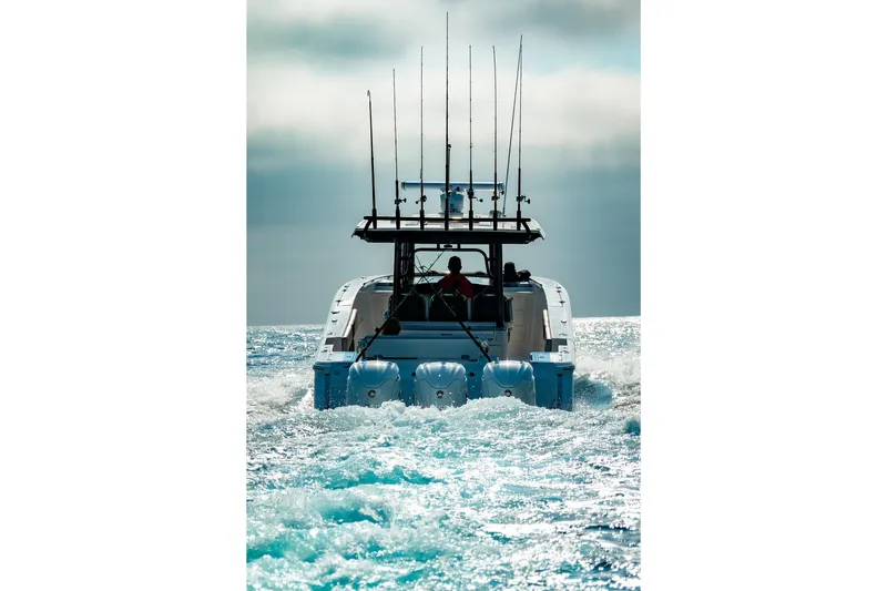 Slide: The Image of 2025 Robalo R360 Center Console cruising on open water, rear view. - 23