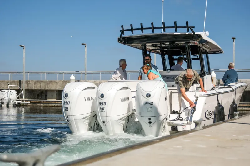 Slide: The Image of 2025 Robalo R360 Center Console boat docked with Yamaha 350 engines. - 9