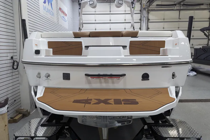 Slide: The Image of 2026 Axis T250 boat interior with tan and white cushioned seating. - 14