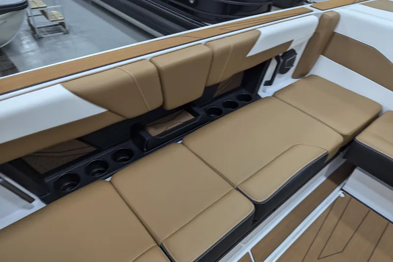 Slide: The Image of 2026 Axis T250 boat interior with tan seating and cup holders. - 17