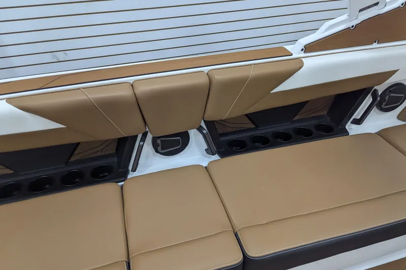 Slide: The Image of 2026 Axis T250 boat interior with tan seating and modern dashboard in a garage setting. - 22