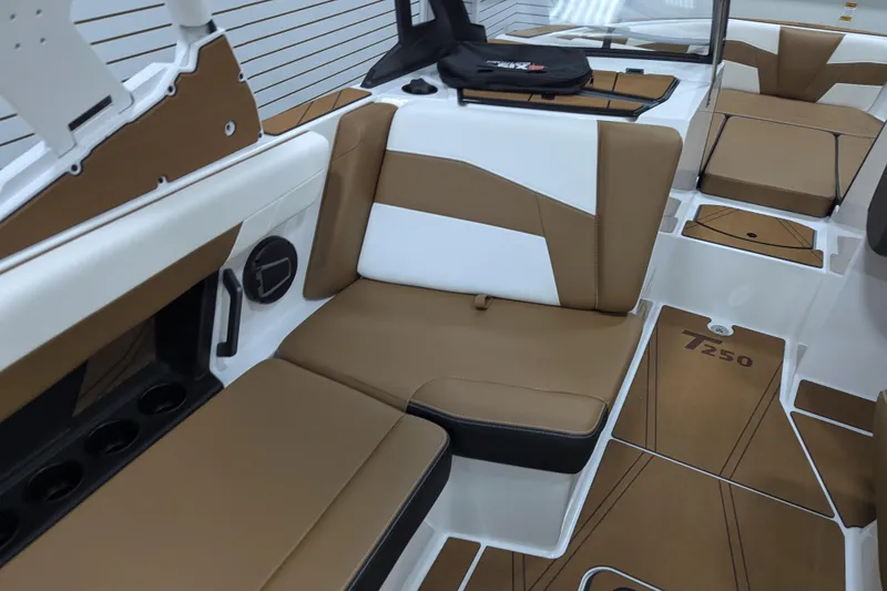 Slide: The Image of 2026 Axis T250 boat interior with tan and white cushioned seating. - 23