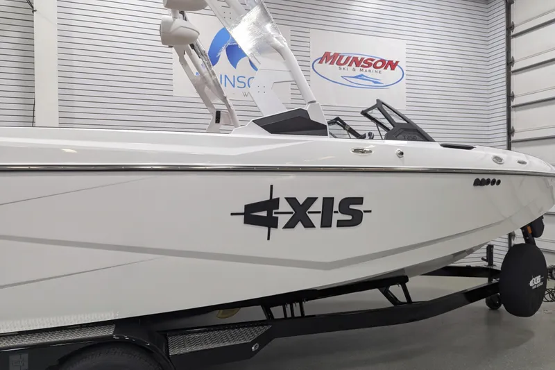 Slide: The Image of 2026 Axis T250 boat displayed indoors at Munson Ski & Marine showroom. - 5
