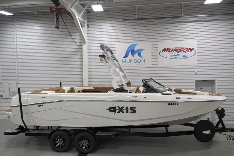 Slide: The Image of 2026 Axis T250 boat displayed indoors at Munson Surf Wake showroom. - 8