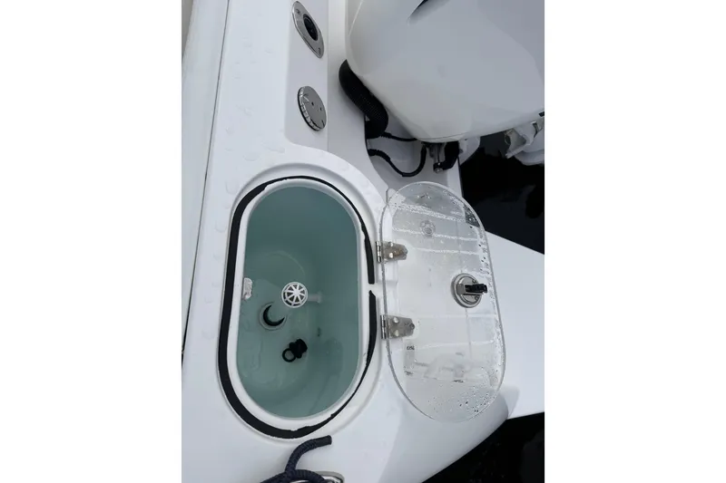 Slide: The Image of 2019 Edgewater 230CC boat cruising on open water, rear view. - 15