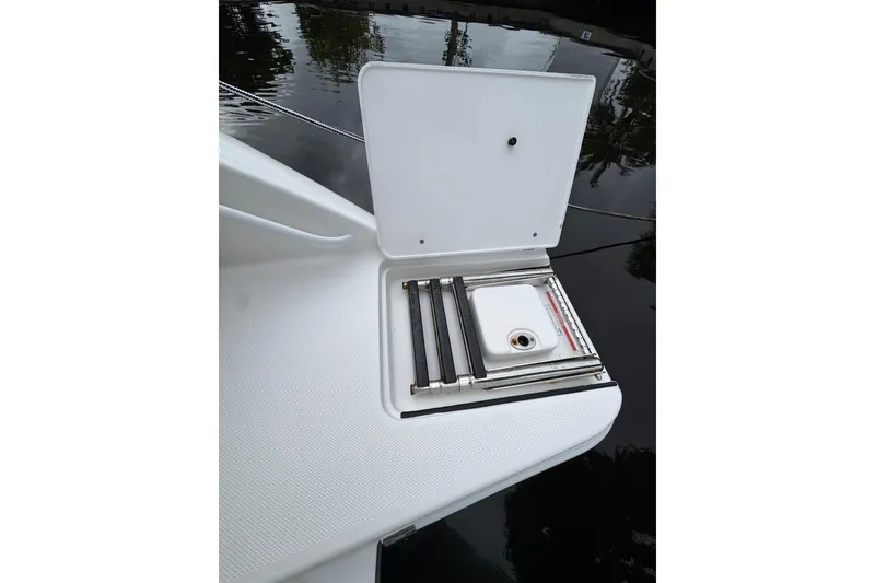 Slide: The Image of Livewell compartment on a 2019 Edgewater 230CC boat, featuring a transparent lid. - 19