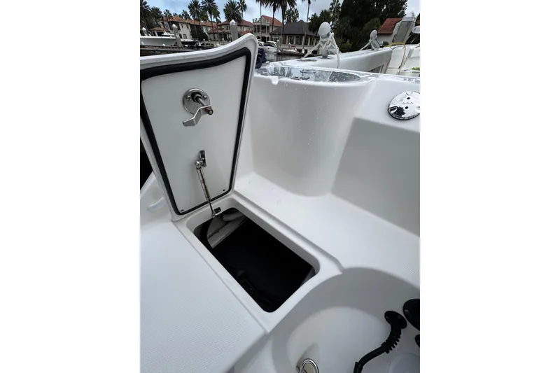 Slide: The Image of Livewell interior of 2019 Edgewater 230CC boat, showing water and drain components. - 20