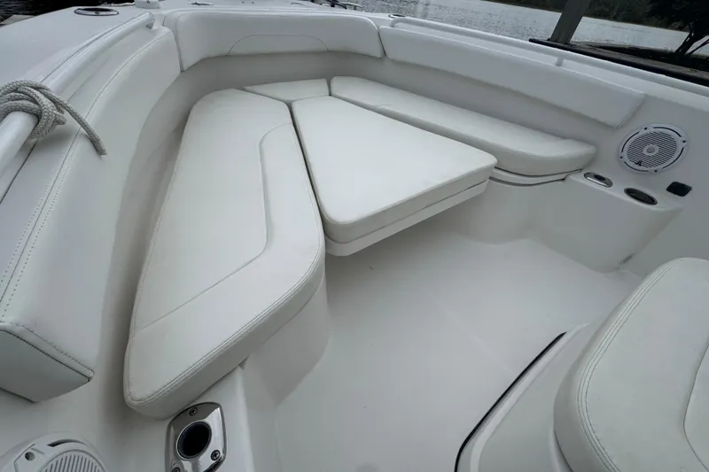 Slide: The Image of Edgewater 230CC 2019 boat docked in a marina with waterfront homes in the background. - 28