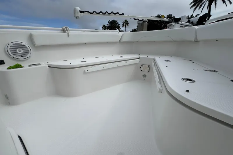 Slide: The Image of 2019 Edgewater 230CC boat interior with teak-style deck and cup holders. - 32
