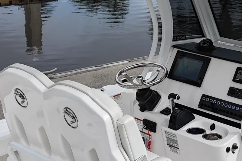 Slide: The Image of Battery compartment of a 2019 Edgewater 230CC boat, featuring dual blue batteries. - 39