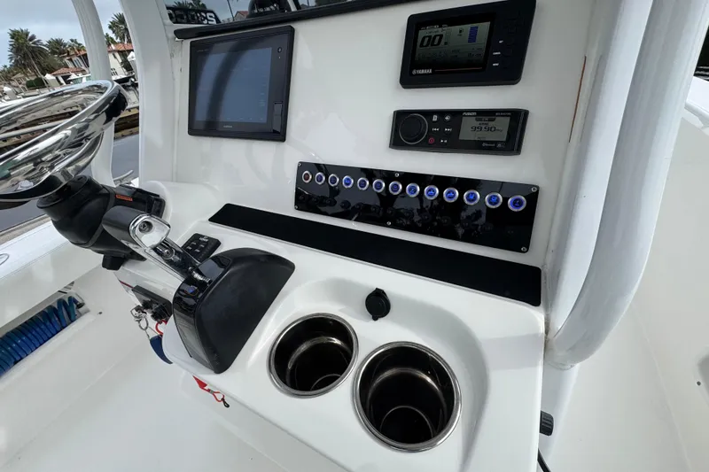Slide: The Image of Yamaha and Fusion control panels on 2019 Edgewater 230CC boat dashboard. - 45