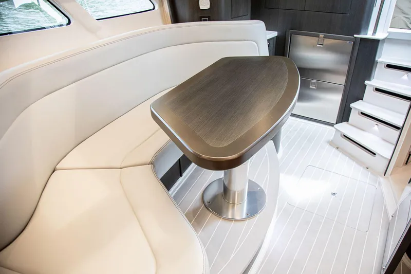Slide: The Image of Manufacturer Provided Image: Luxurious interior of 2021 Intrepid 410 Evolution yacht with elegant seating and table. - 13