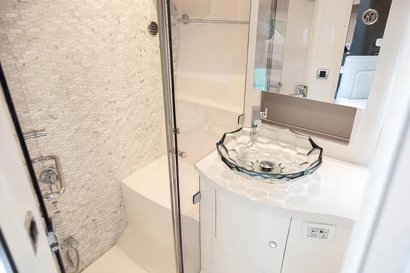 Slide: The Image of Manufacturer Provided Image: Modern bathroom in 2021 Intrepid 410 Evolution yacht with glass sink and shower. - 17