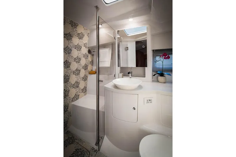 Slide: The Image of Manufacturer Provided Image: Modern bathroom in 2021 Intrepid 410 Evolution yacht with floral wallpaper and sleek fixtures. - 18