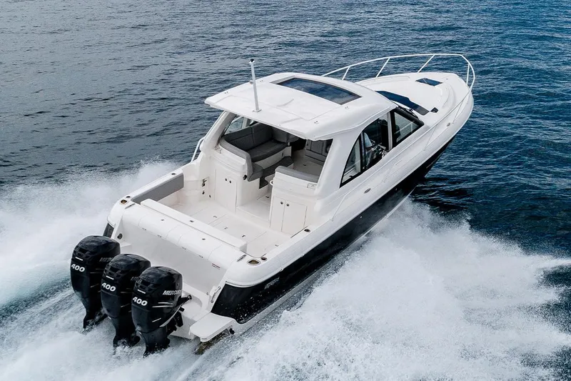 Slide: The Image of Manufacturer Provided Image: 2021 Intrepid 410 Evolution boat cruising on water with triple outboard engines. - 2