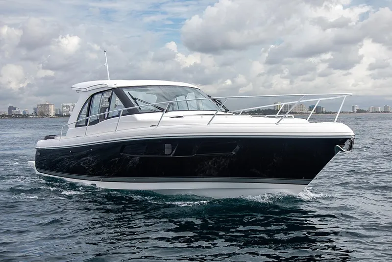 Slide: The Image of Manufacturer Provided Image: 2021 Intrepid 410 Evolution boat cruising on open water under cloudy skies. - 4