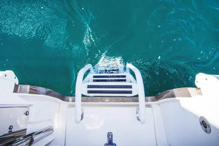 Slide: The Image of Manufacturer Provided Image: View from Intrepid 410 Evolution 2021 boat ladder into clear blue water. - 7