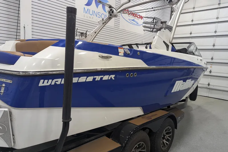Slide: The Image of 2021 Malibu Wakesetter 22 LSV boat in showroom, blue and white design. - 11
