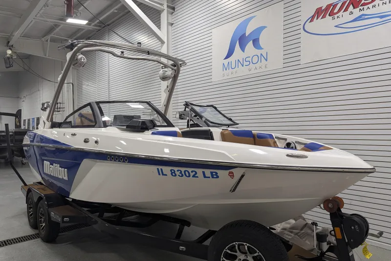 Slide: The Image of 2021 Malibu Wakesetter 22 LSV boat in showroom, Munson Surf Wake signage visible. - 12