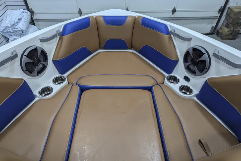 Slide: The Image of 2021 Malibu Wakesetter 22 LSV interior with tan and blue seating, speakers, and cup holders. - 20