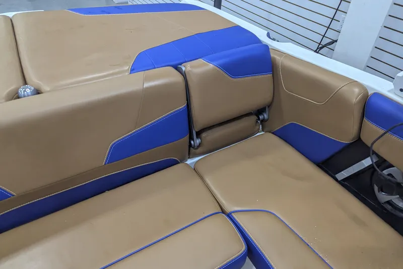 Slide: The Image of 2021 Malibu Wakesetter 22 LSV interior with tan and blue seating. - 26