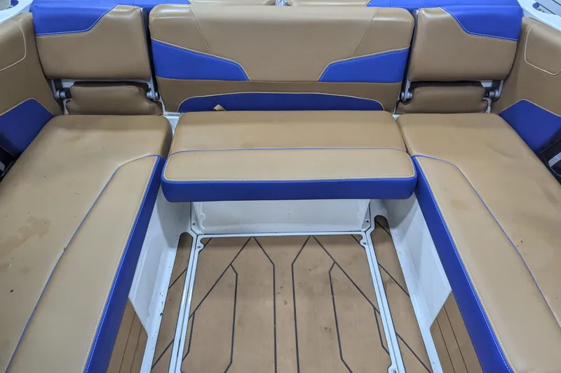 Slide: The Image of 2021 Malibu Wakesetter 22 LSV interior seating with tan and blue upholstery. - 29