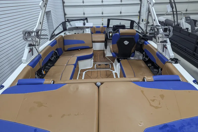 Slide: The Image of 2021 Malibu Wakesetter 22 LSV interior with tan and blue seating, modern dashboard. - 30