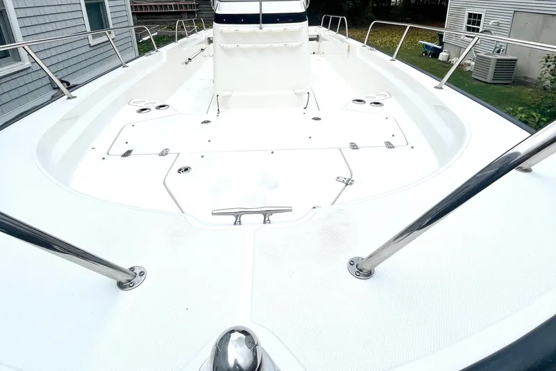 Slide: The Image of 2020 Boston Whaler 210 Montauk with Mercury outboard motor, parked near a house. - 10