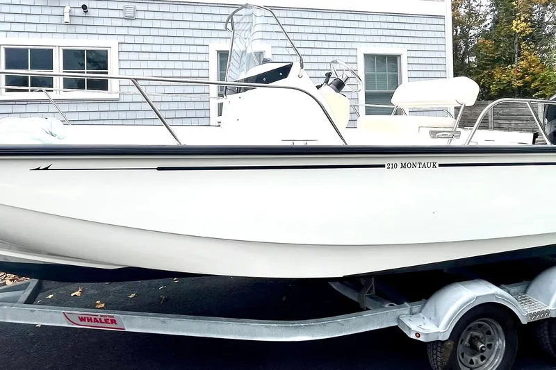 Slide: The Image of 2020 Boston Whaler 210 Montauk boat interior with steering console and seating. - 13