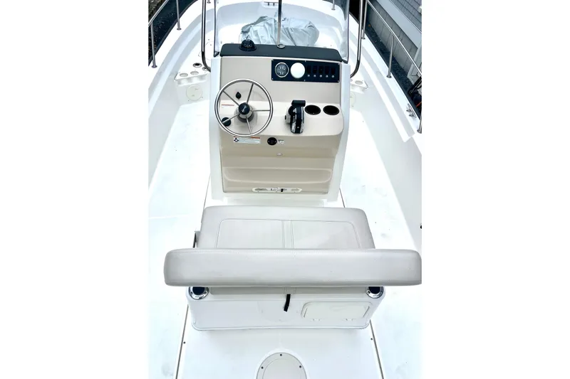 Slide: The Image of 2020 Boston Whaler 210 Montauk boat with open storage compartments and Mercury outboard engine. - 22