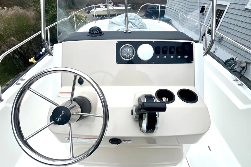 Slide: The Image of 2020 Boston Whaler 210 Montauk boat console with steering wheel and controls. - 23