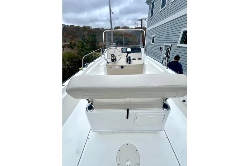 Slide: The Image of 2020 Boston Whaler 210 Montauk boat engine, viewed from above, on grassy background. - 27