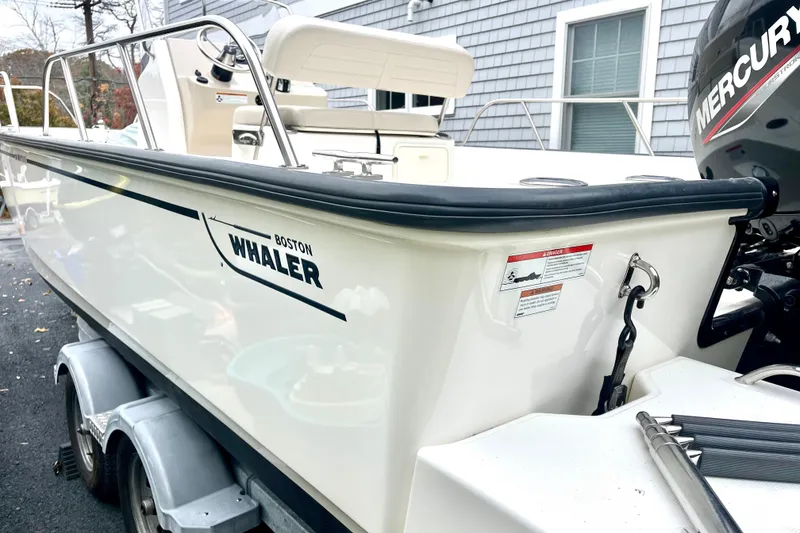 Slide: The Image of 2020 Boston Whaler 210 Montauk boat on trailer, featuring Mercury engine. - 5