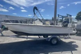 Slide: The Image of 2024 Boston Whaler 190 Montauk boat on trailer under clear blue sky. - 1
