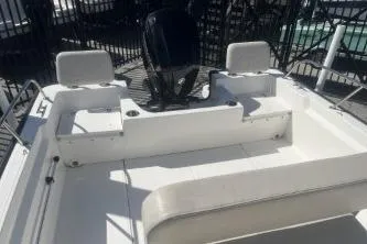 Slide: The Image of 2024 Boston Whaler 190 Montauk boat interior with seating and motor. - 10