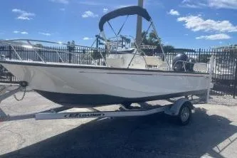 Slide: The Image of 2024 Boston Whaler 190 Montauk boat on trailer, outdoor display. - 2